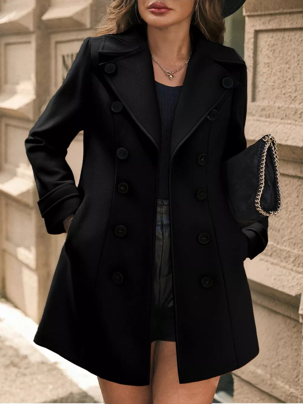 Black double-breasted wool blend trench coat with cuffed sleeves and a-line cut.