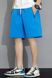 Sky blue quick-dry men's shorts with drawstring and zippered pockets.