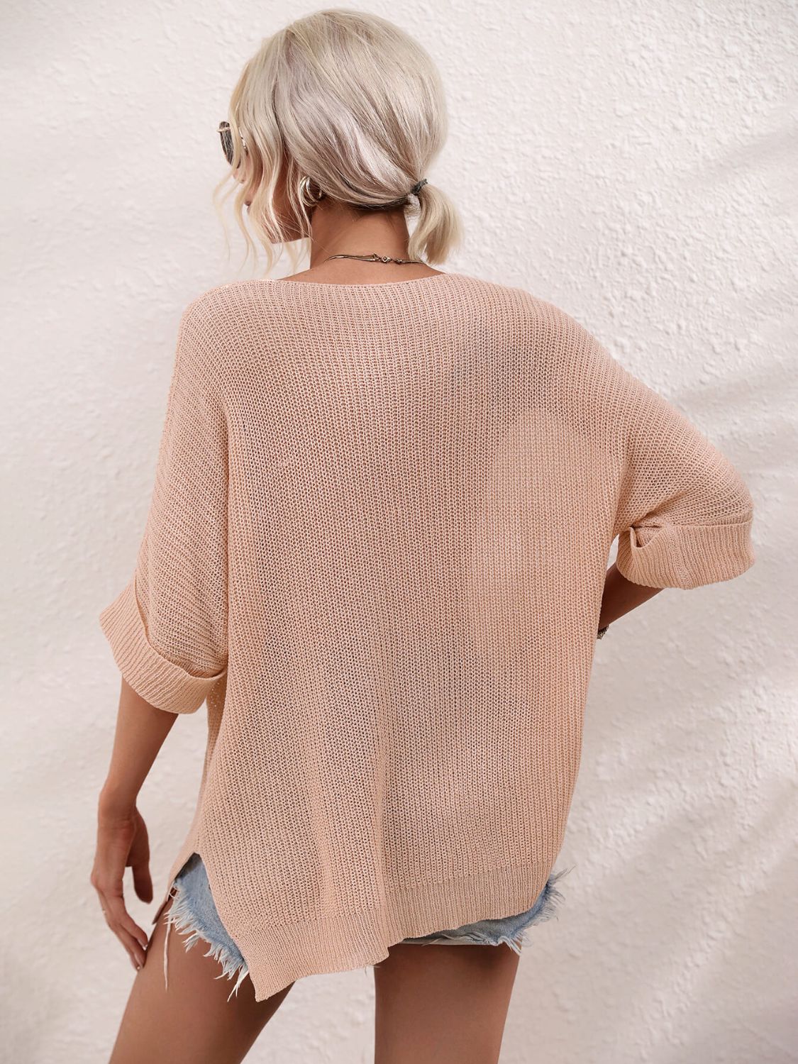 Relaxed knit tunic top in ivory with boat neck and cuffed short sleeves.
