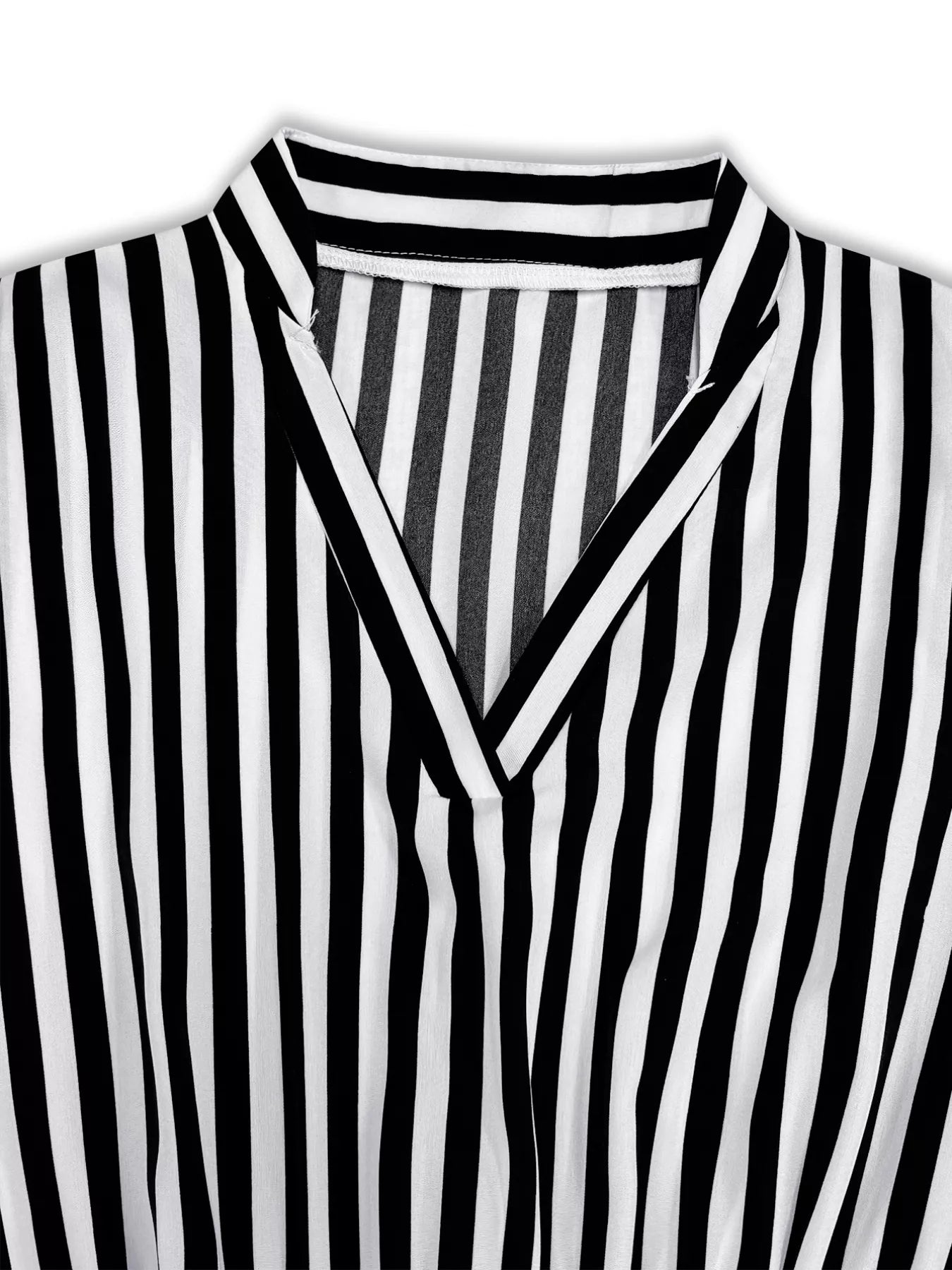 Notched long-sleeve midi dress in black and white stripe with V-neckline.