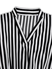 Notched long-sleeve midi dress in black and white stripe with V-neckline.