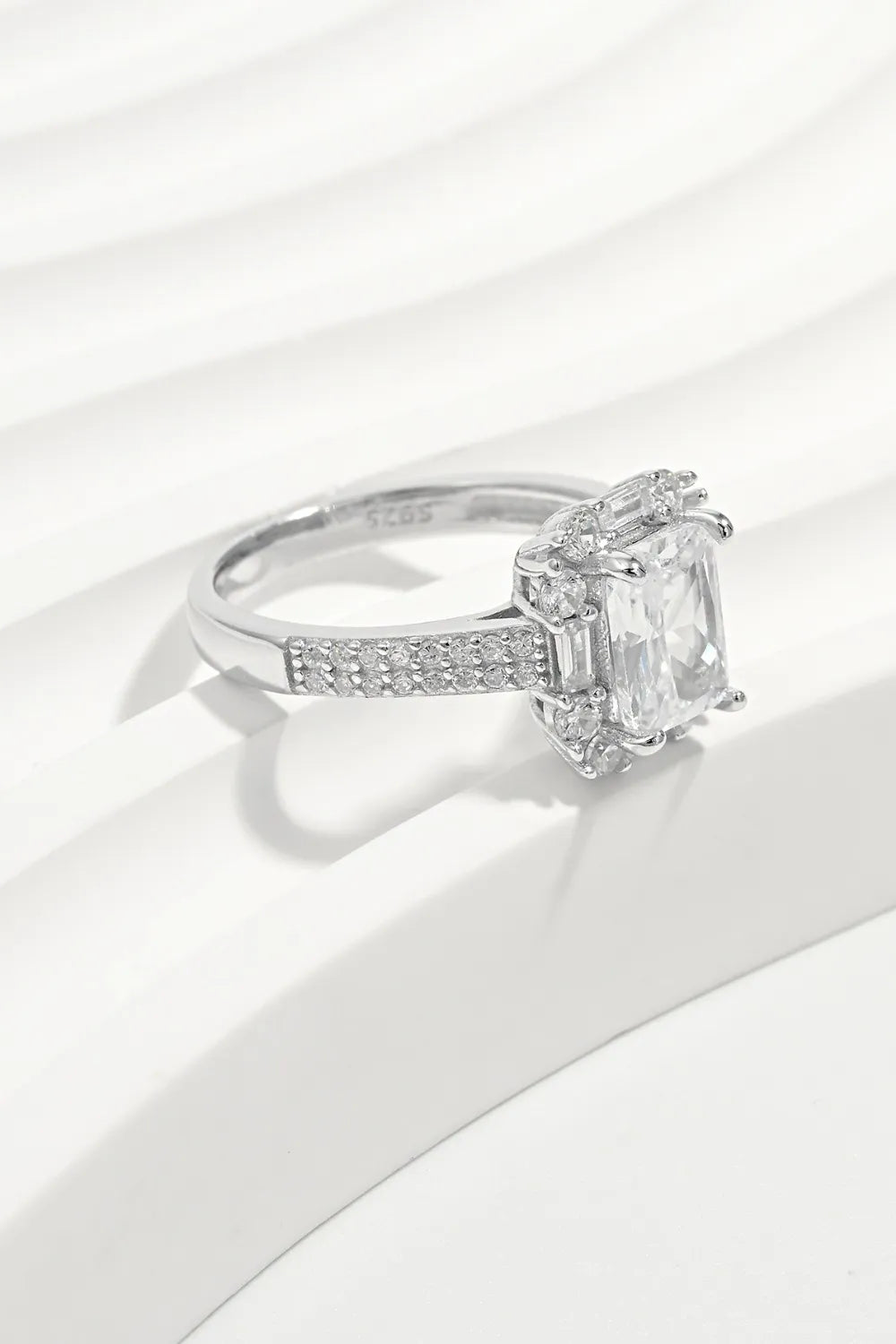 Silver emerald cut halo ring with pave band and baguette accents