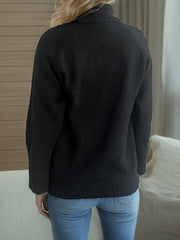 Black ribbed turtleneck sweater with subtle sparkle detail and raglan sleeves.