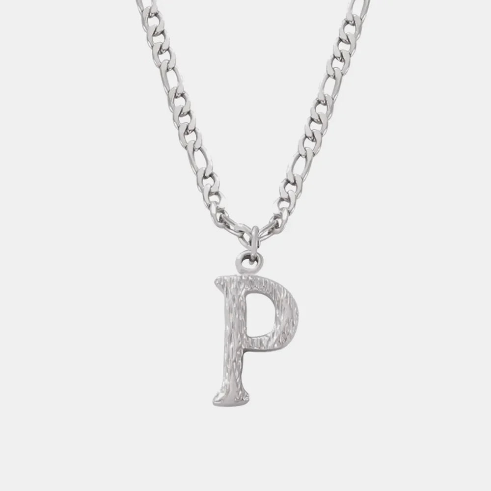 Textured initial pendant necklace with a silver chain and a silver letter P charm.