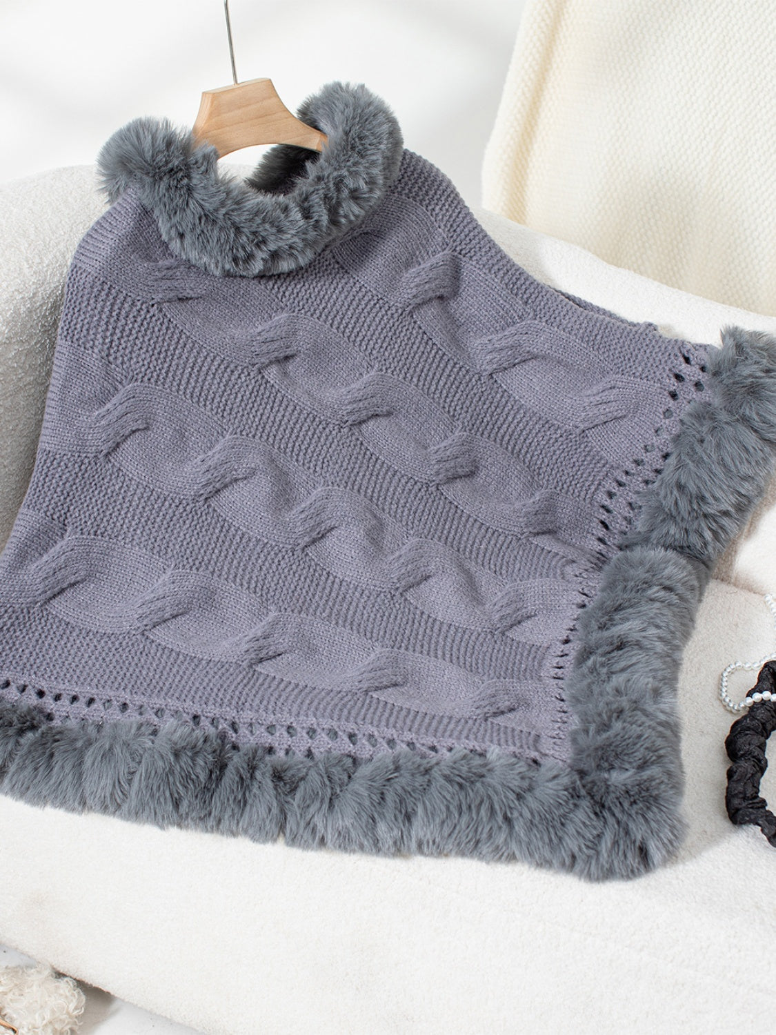Dark Gray cable knit poncho with faux fur trim and open knit detail.
