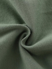 Green cotton knit fabric detail, showing texture and weave.
