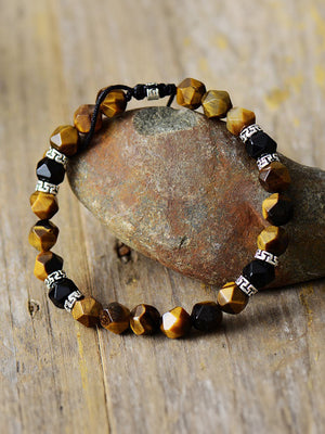 Prismatic stone bead bracelet with tiger's eye and black agate beads, adjustable cord.