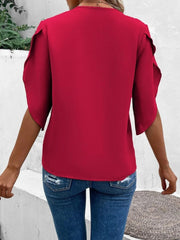 Deep red blouse with scalloped lace trimmed flutter sleeves and a V-neck.