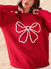 Red ribbed sweater with white bow detail and mock neckline.