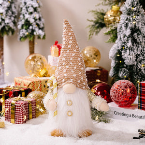 Illuminated festive gnome with white beard, holding candy cane, wearing dotted hat and pearl buttons.