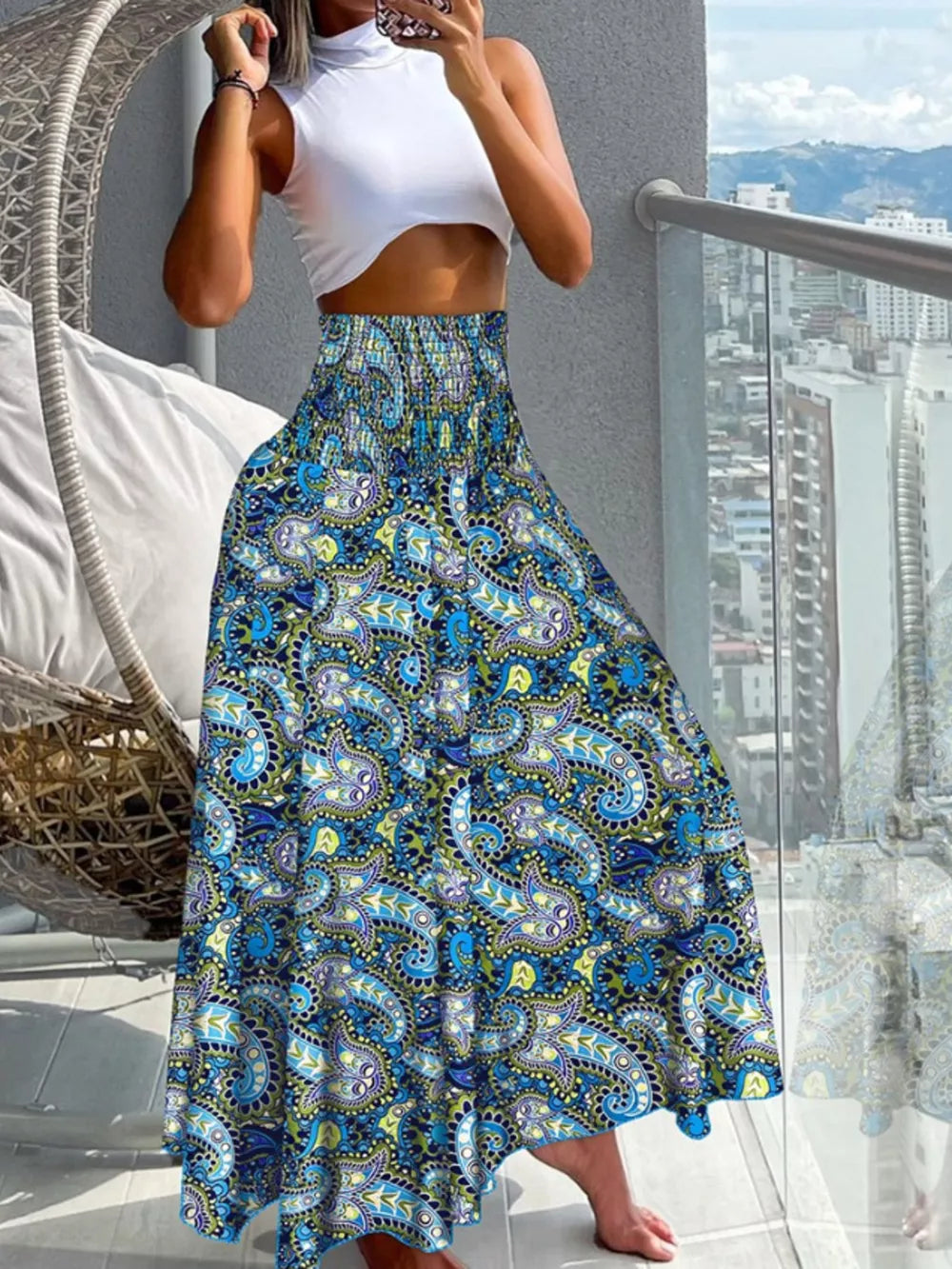 Bohemian print smocked waist maxi skirt in royal blue with paisley pattern.