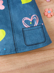 Baby dress with blue denim print, pink and yellow hearts, and a functional pocket.