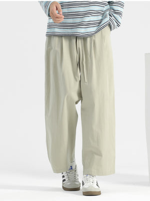 Men's sage wide-leg casual trousers with drawstring waist and relaxed fit.