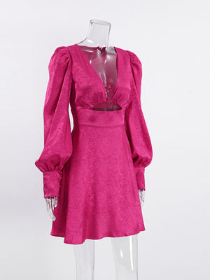 Vibrant mini dress with deep V-neck, cutout detail, and lantern sleeves in cerise.