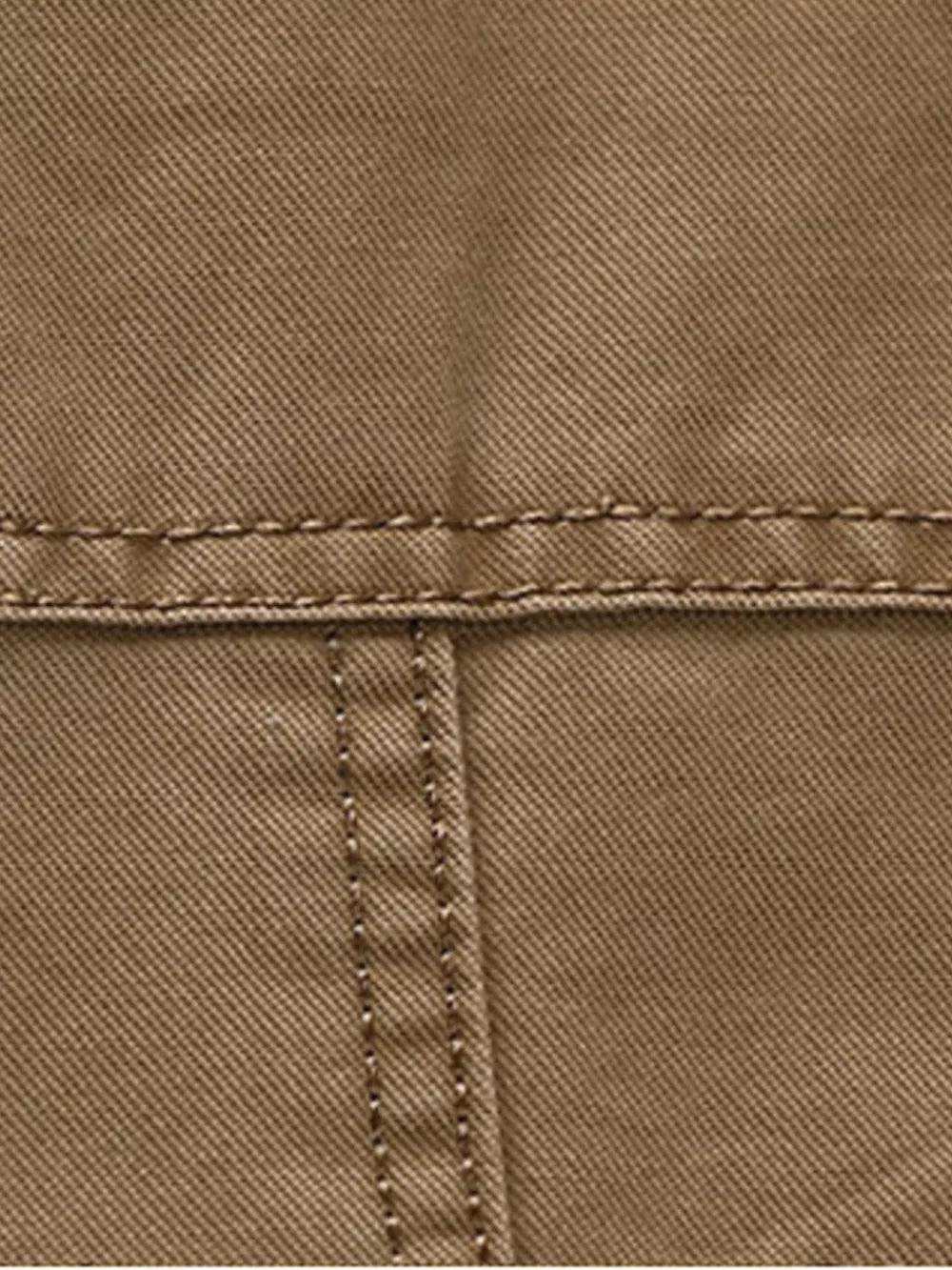 Khaki cotton blazer detail showing stitching and fabric texture.