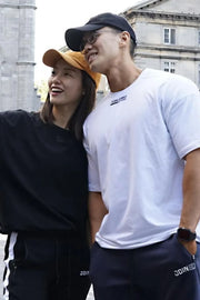 White oversized t-shirt with black logo detail on chest