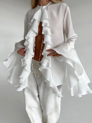 White ruffled flounce sleeve blouse with a buttoned neckline and airy fabric.