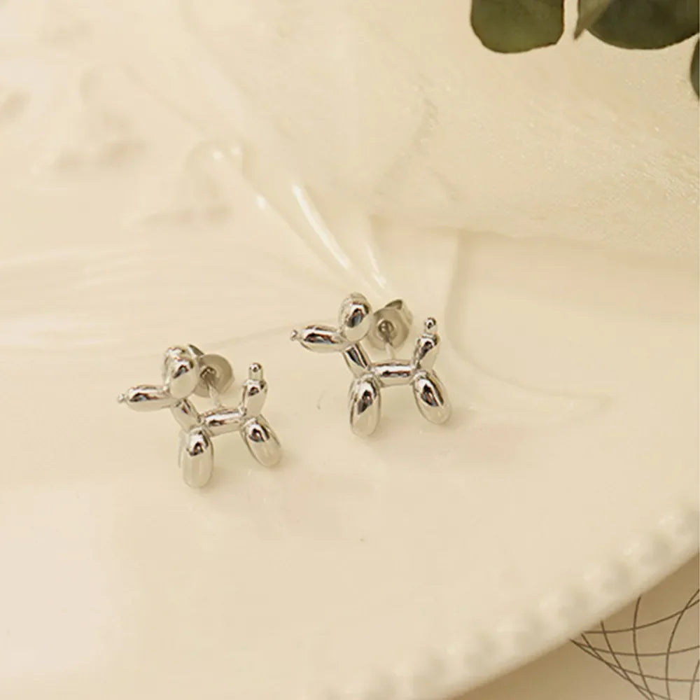 Silver balloon dog sculptural stud earrings with post backs.