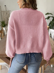 Blush pink bubble sleeve cardigan with pearl buttons and ribbed cuffs.
