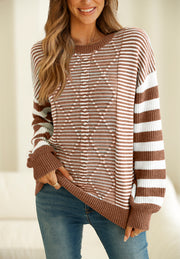 Brown and white geometric stripe knit sweater with crew neck and long sleeves.