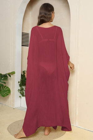 Deep red oversized caftan cover-up with side slits, sheer fabric, V-neck, batwing sleeves.