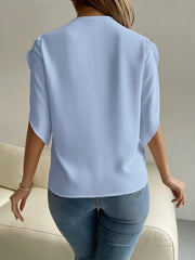 Light blue polyester blouse with cape sleeves and lace trim detail.