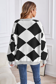 Diamond knit balloon sleeve cardigan in black and white argyle pattern.