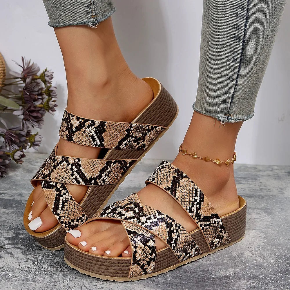 Braided strap platform slides in serpentine snakeskin pattern with a thick sole.