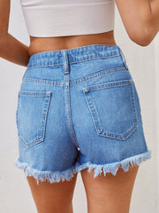 Light blue denim shorts with frayed hem and distressed details.
