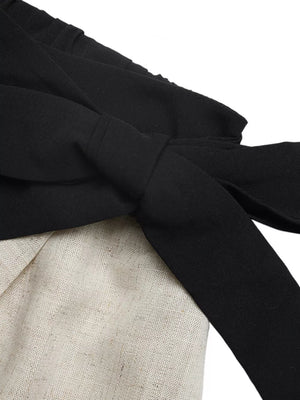 Black linen-blend cami and skort ensemble with contrast trim and bow detail.