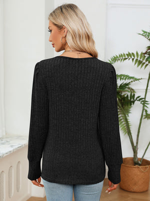 Black ribbed knit sweater with crochet trim detail, long sleeves, and crew neck.