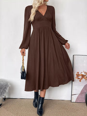 Brown V-neck midi dress with puff sleeves and A-line skirt.