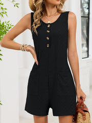 Black buttoned sleeveless romper with textured fabric and patch pockets.