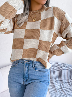 Checkerboard knit mock neck pullover sweater in camel and white acrylic with long sleeves.