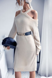 Cream knit cold shoulder halter dress with long sleeves and a belted waist.