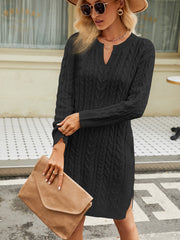 Black cable knit sweater dress with keyhole neckline and long sleeves.