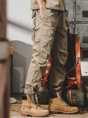 Men's khaki cargo jogger pants with multiple pockets and zippered ankles.
