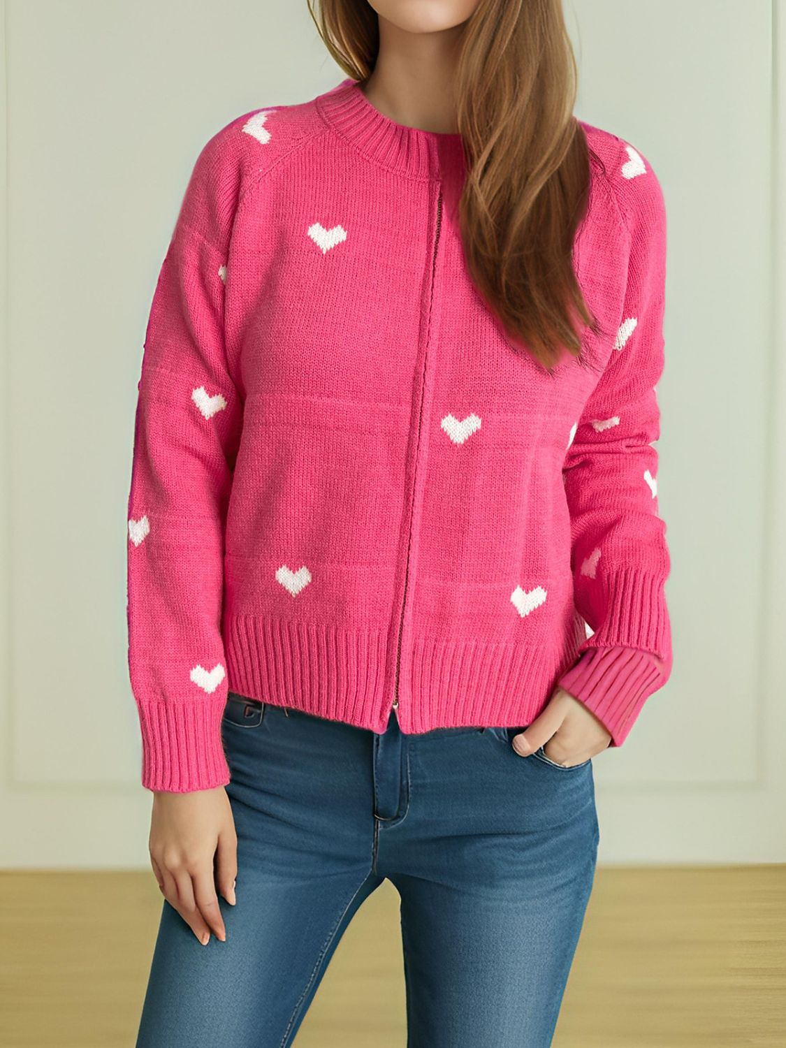 Hot Pink zip-through knit cardigan with white heart pattern, crew neck, long sleeves.