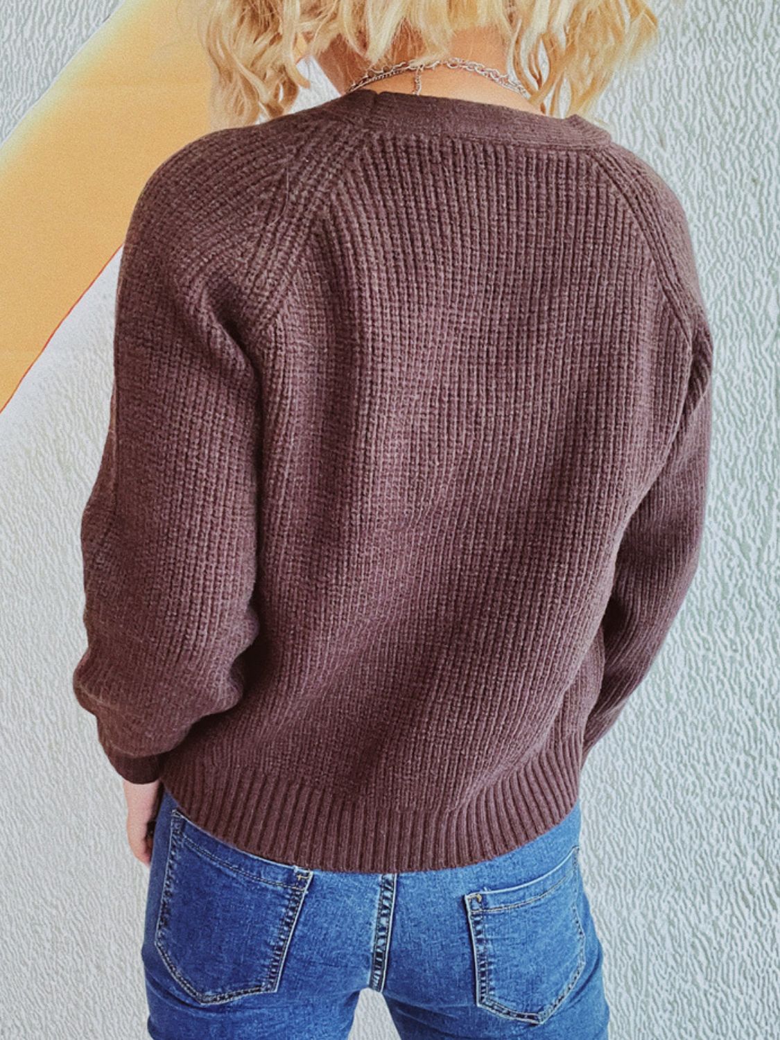 Brown cable knit raglan cardigan with ribbed details and buttoned front.