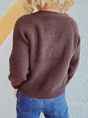 Brown cable knit raglan cardigan with ribbed details and buttoned front.