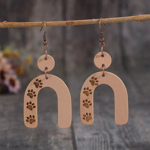 Wooden arch earrings in camel with engraved paw prints and copper hooks