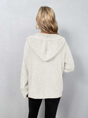 White hooded knit cardigan with button front and ribbed cuffs.