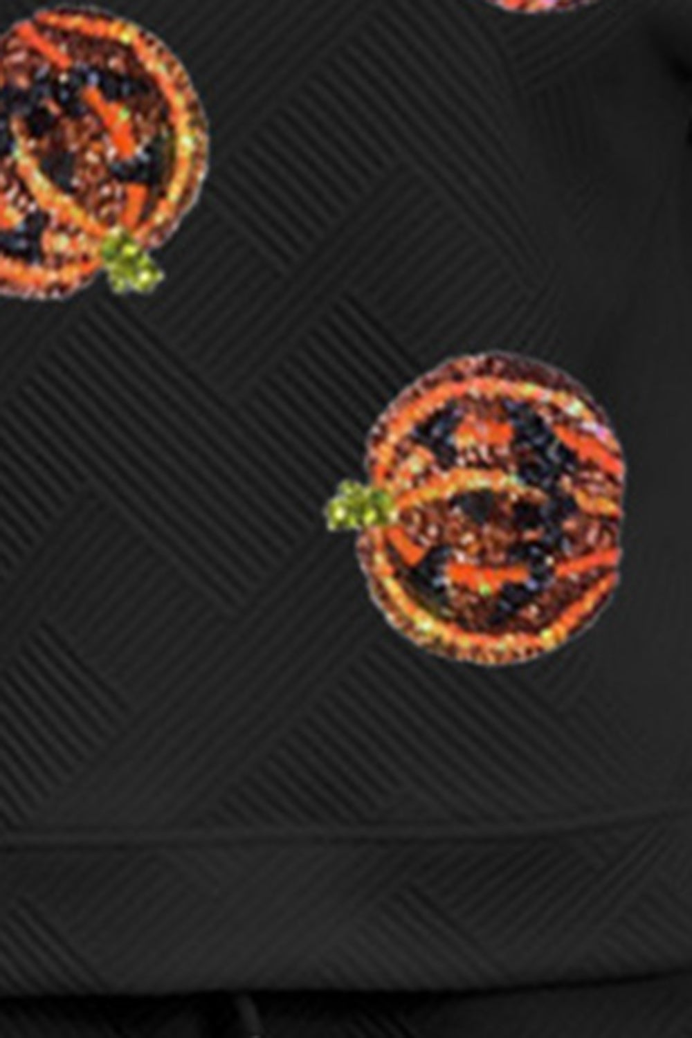 Black loungewear top with allover textured pumpkin print and subtle geometric pattern.