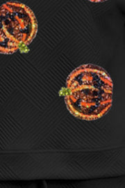 Black loungewear top with allover textured pumpkin print and subtle geometric pattern.