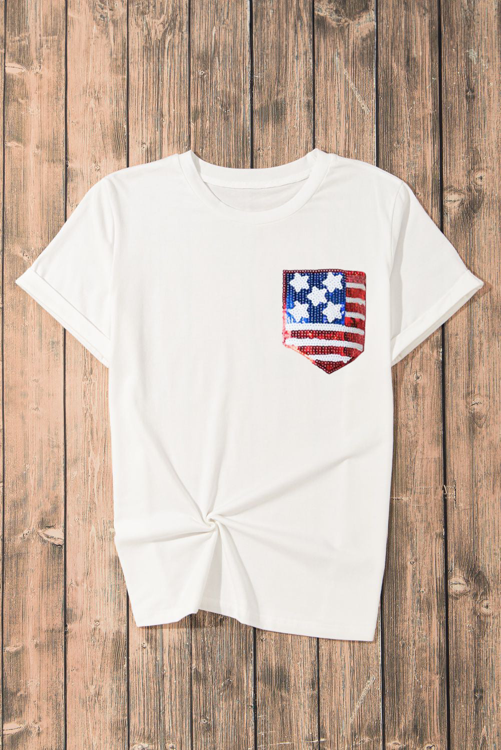 White cotton blend t-shirt with a sequined American flag pocket detail.