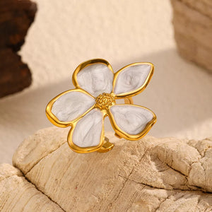 Lustrous gold open ring with a cream enamel floral design and textured center.