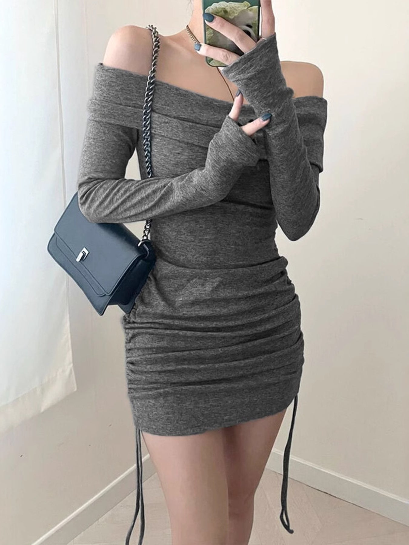 Grey ruched bodycon mini dress with off-the-shoulder neckline and drawstring detail.