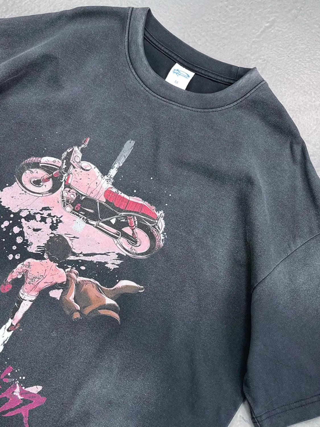 Black oversized washed tee with Akira motorcycle graphic print