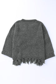 Distressed knit sweater in dark gray with frayed hem and distressed details.