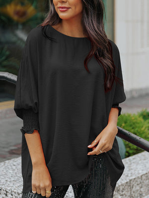 Black textured sleeve blouse with elastic cuffs and a round neckline.